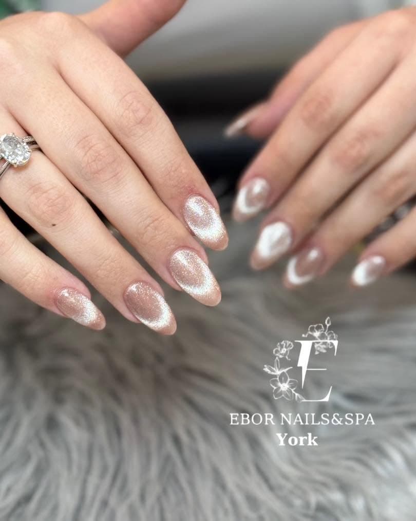 Almond nails with a soft white cat-eye shimmer